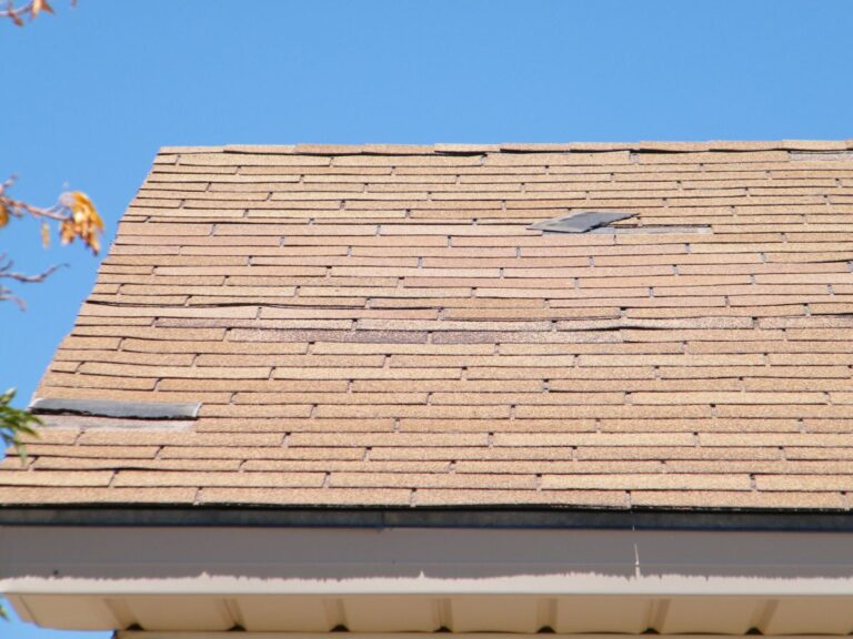 curling shingles orange roof shingles falling blue sky summer time
