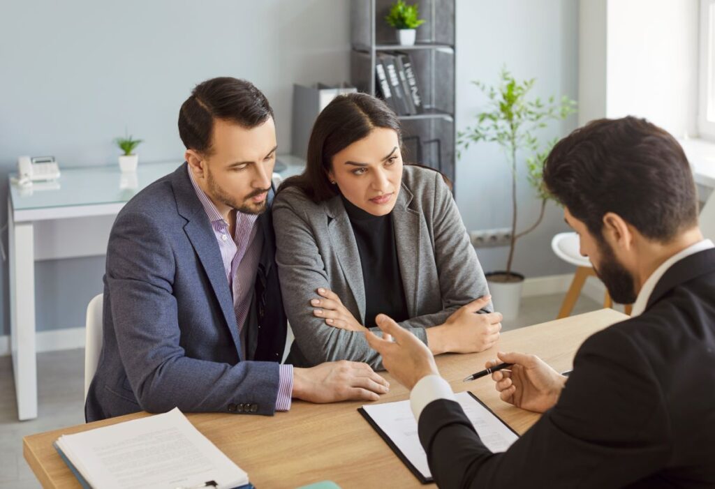 roofing insurance couple talking with manager