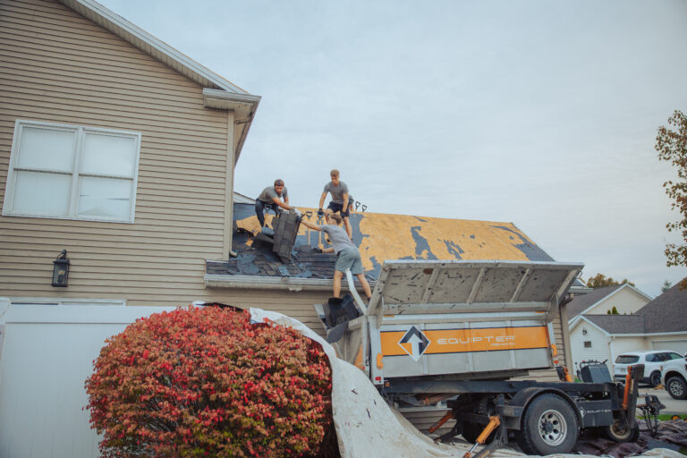 does homeowners insurance cover roof replacement Keim Quality Roofing workers replacing shingles roof