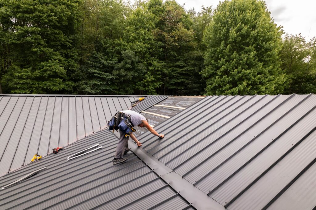 minimum slope for a metal roof worker installing grey metallic roof